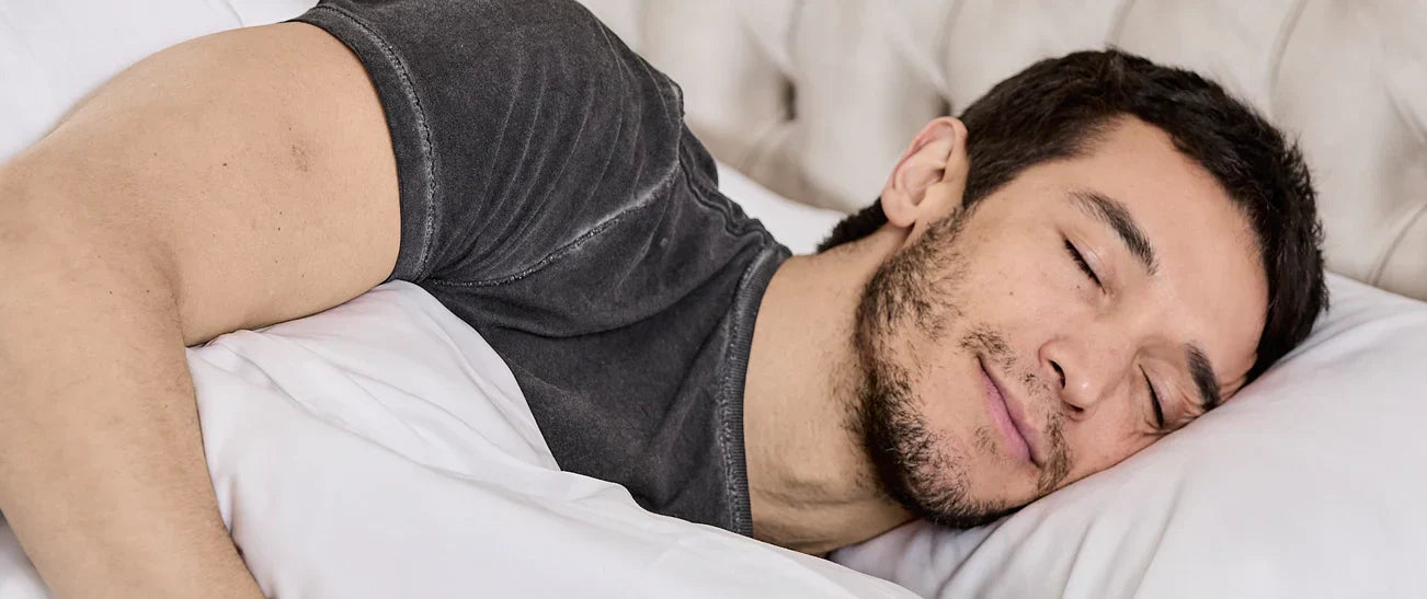 Someone in bed laying in bed.